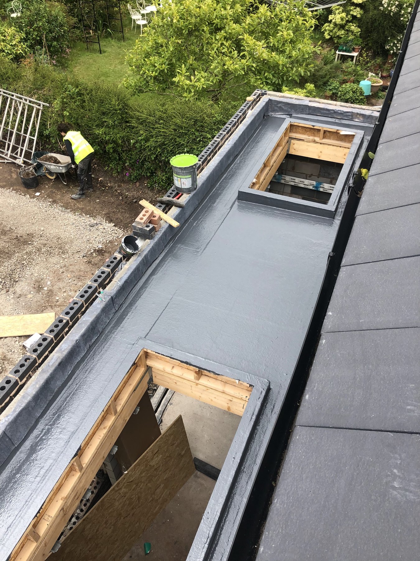 A new flat roof seen from above, with two timber upstands ready for rooflights